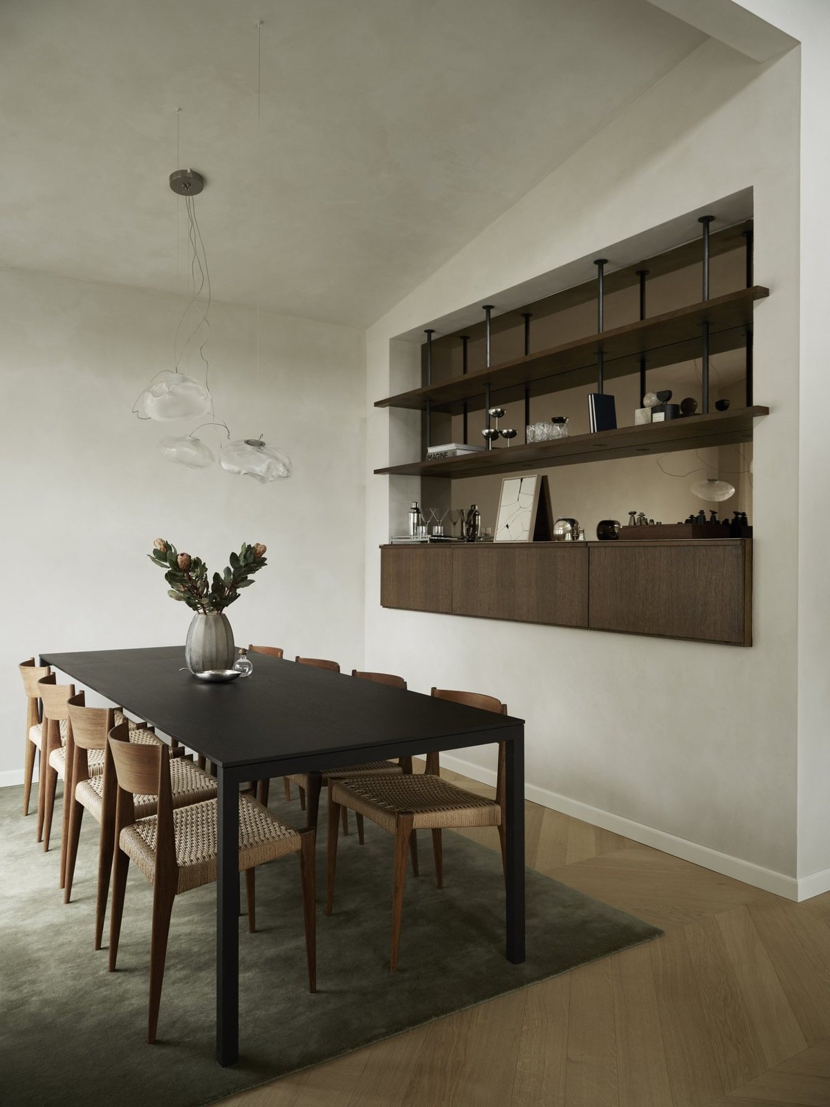 Elegant dining area with dark oak cabinet and built-in open shelving