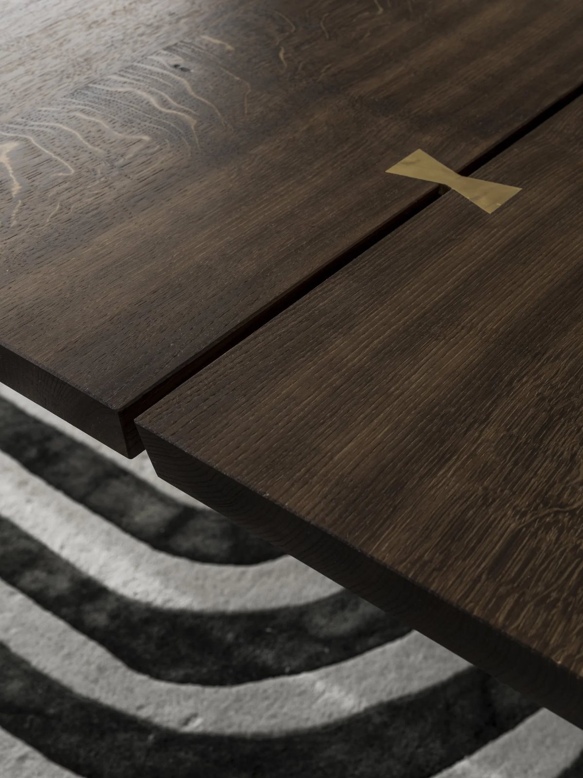 Brass inlays along oak table split