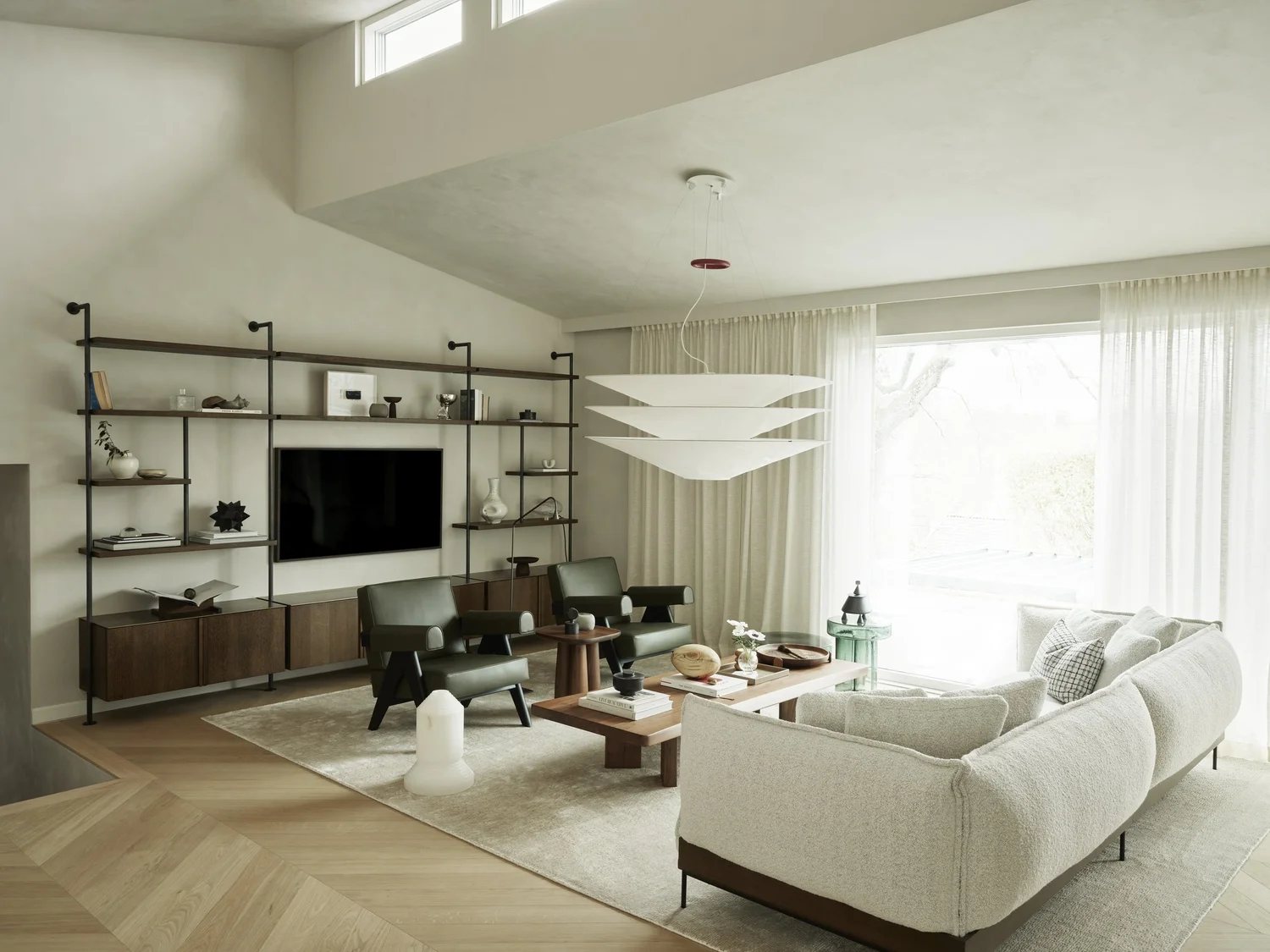 Bright and calm living room with boucle sofa, soft rug, and low walnut coffee table in front of large windows
