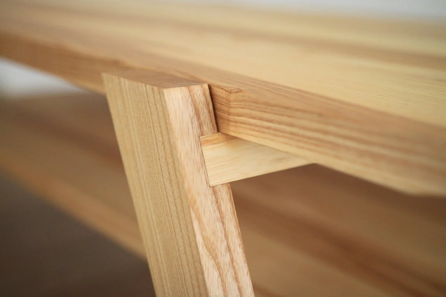 Close-up of interlocking ash wood construction on a handcrafted table