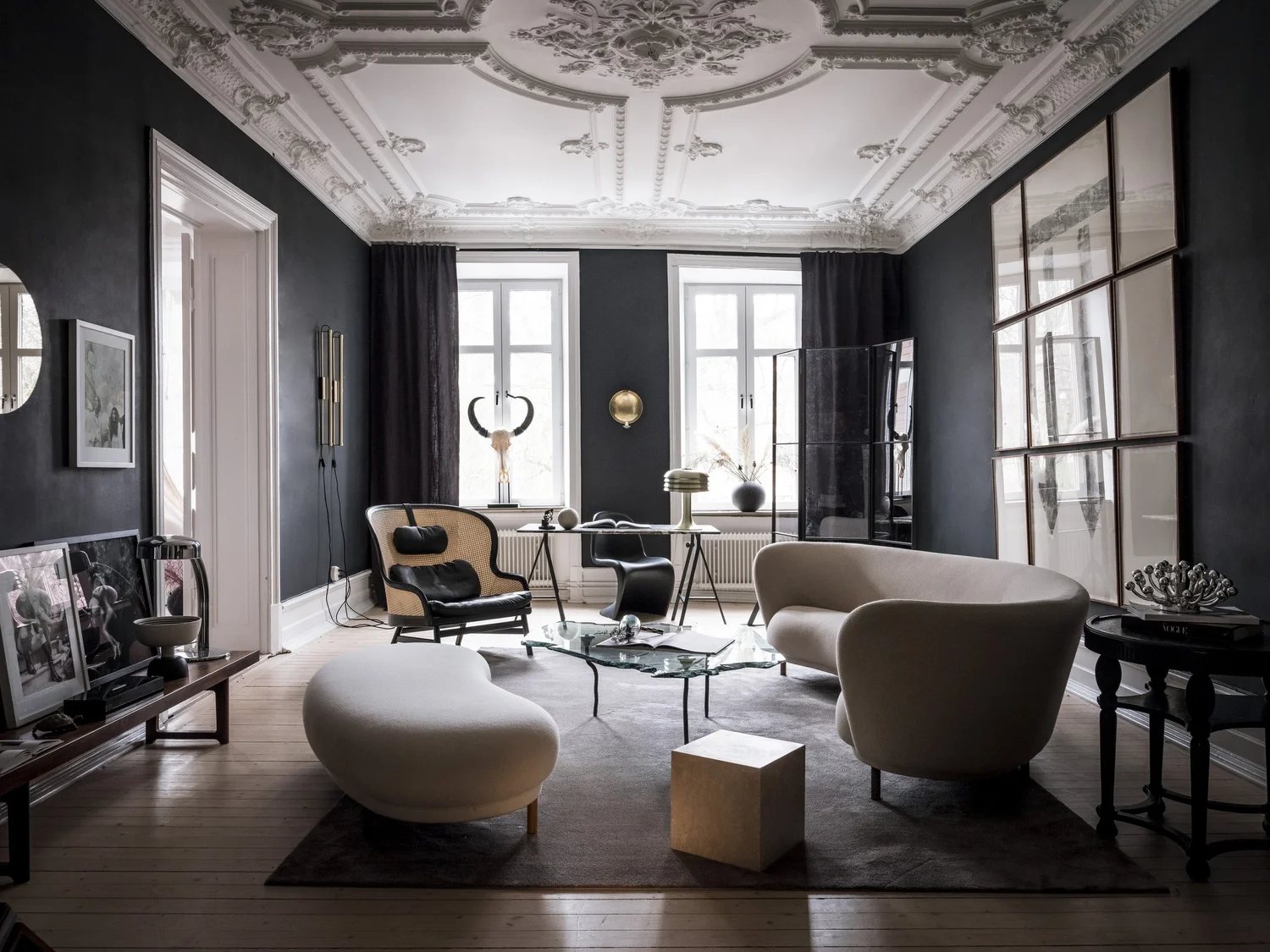 A richly detailed living room with contemporary seating and vintage accents.