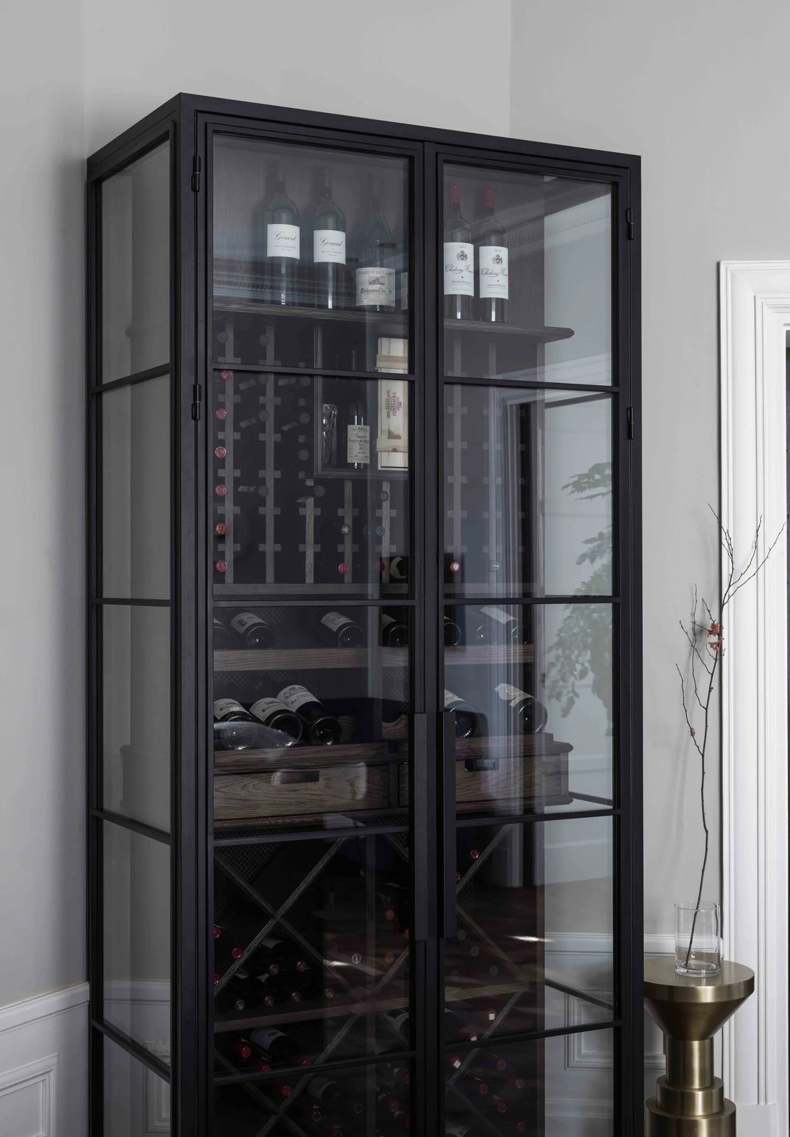 Elegant wine cabinet with black metal frame and oak drawers for bottle organization