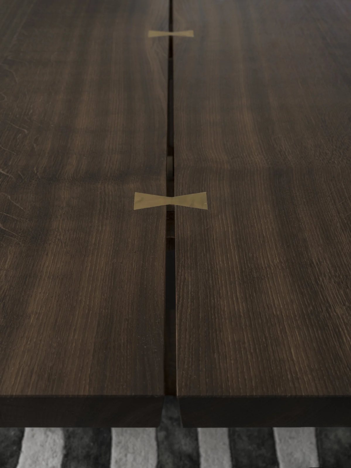 Precision joinery with brass butterfly in oak